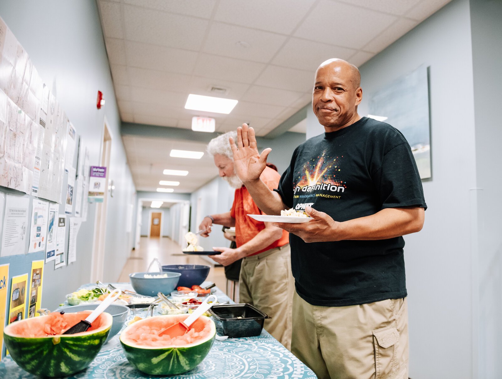 Kent Carter dips a plate during "Super Saturday" a free monthly community meal for the housing members at River's Edge. River's Edge is a  supportive housing complex on Spy Run Ave. Ext. in Fort Wayne.