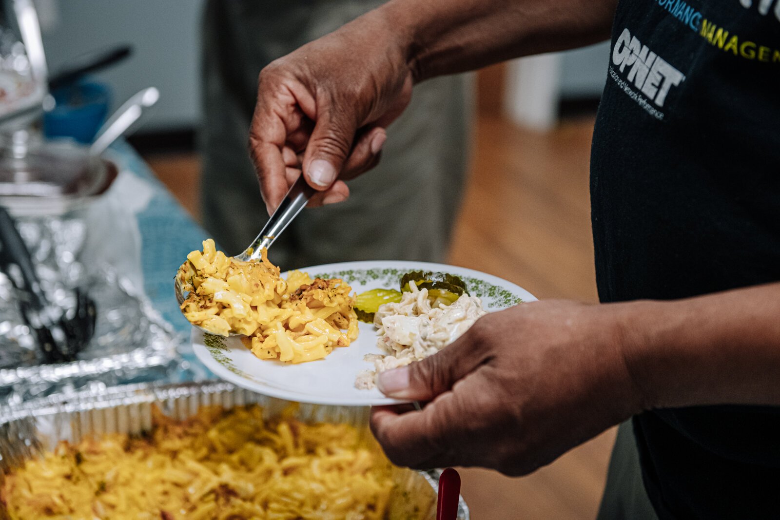 Kent Carter dips a plate during "Super Saturday" a free monthly community meal for the housing members at River's Edge. River's Edge is a  supportive housing complex on Spy Run Ave. Ext. in Fort Wayne.