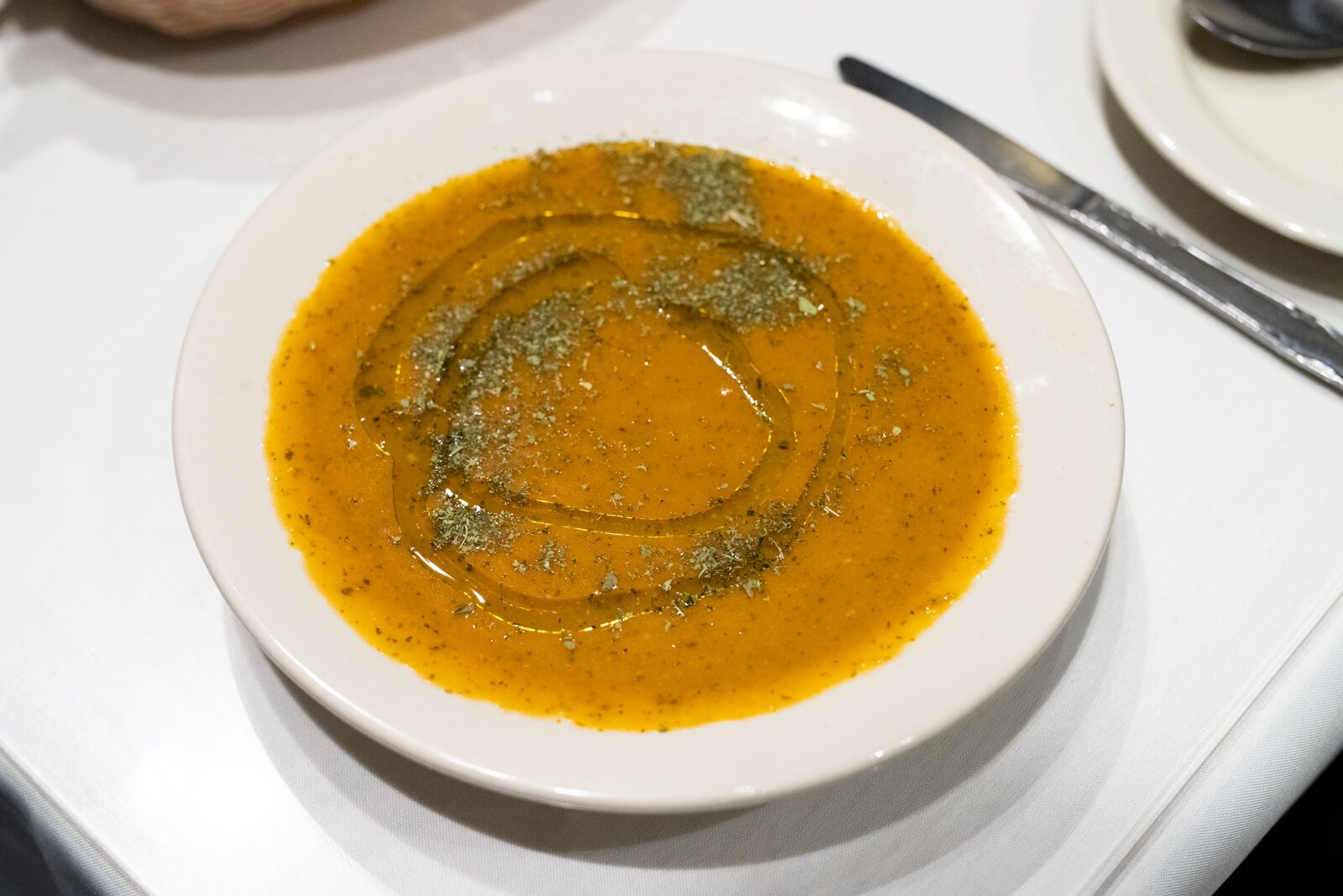 Between its burnt orange hue and the glossy sheen of olive oil laced around its surface, this vegetable soup is stunning to look at.