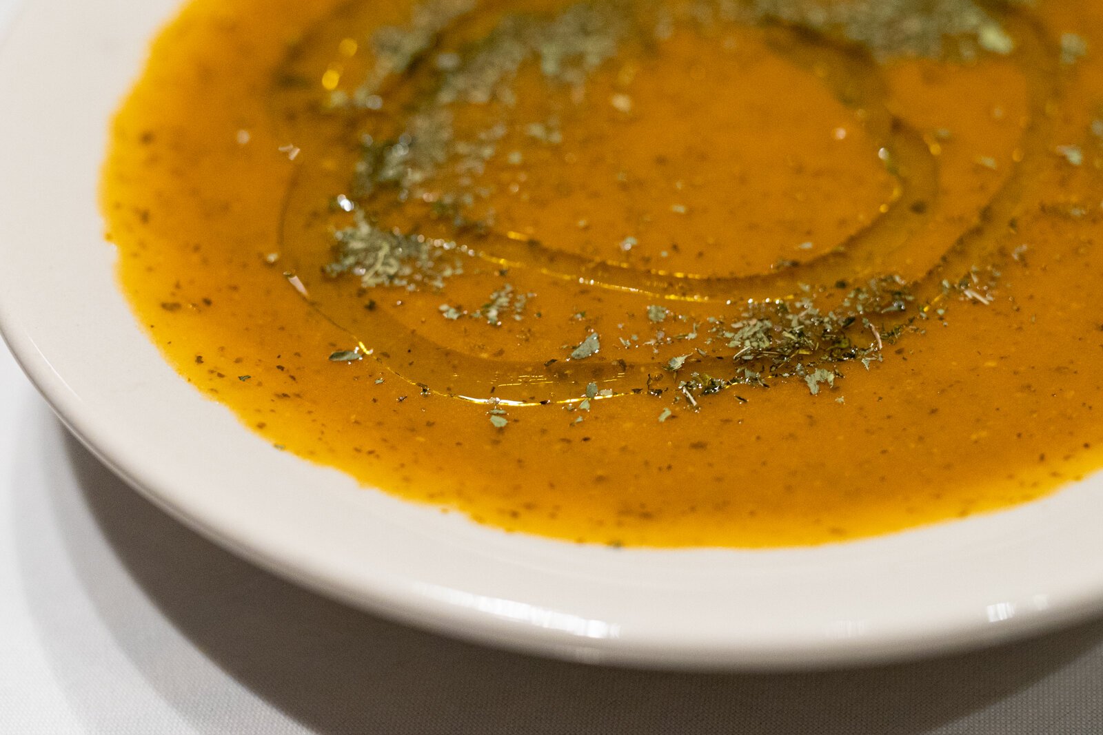 Between its burnt orange hue and the glossy sheen of olive oil laced around its surface, this vegetable soup is stunning to look at.