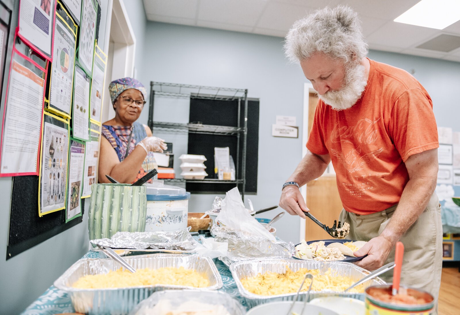 Pete Barbaruolo dips a plate during "Super Saturday" a free monthly community meal for the housing members at River's Edge. River's Edge is a  supportive housing complex on Spy Run Ave. Ext.