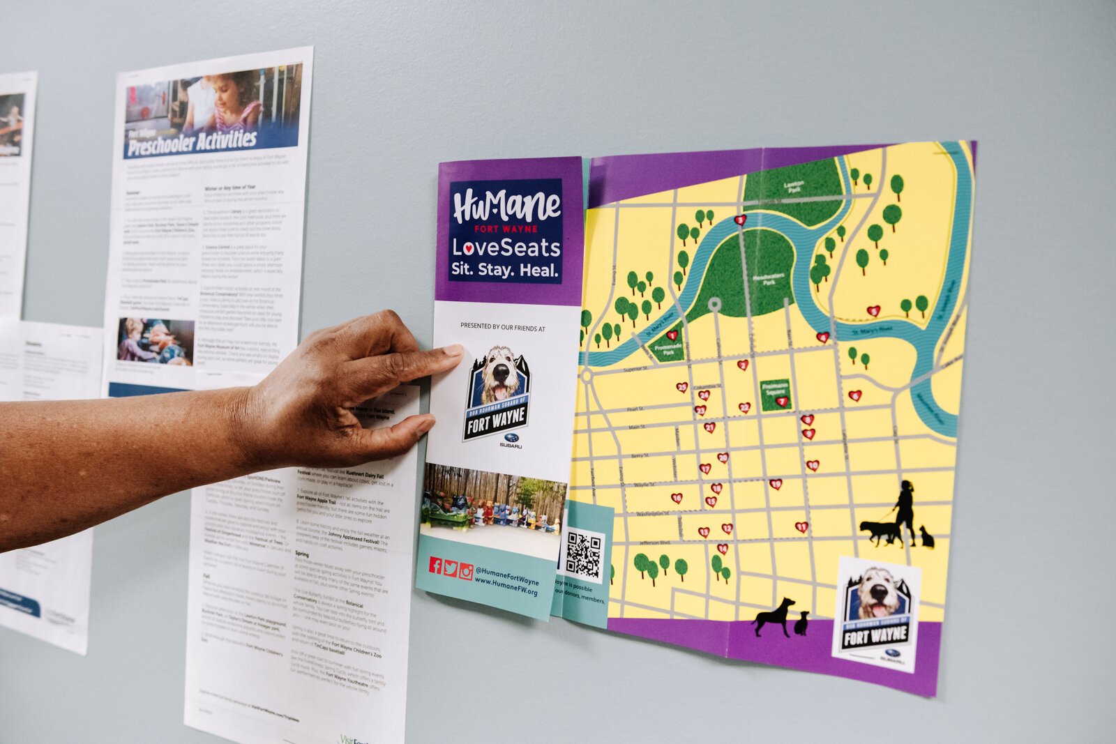 Denise Porter shows off some of the resource information hung up on the wall at River's Edge, a supportive housing complex on Spy Run Ave. Ext.