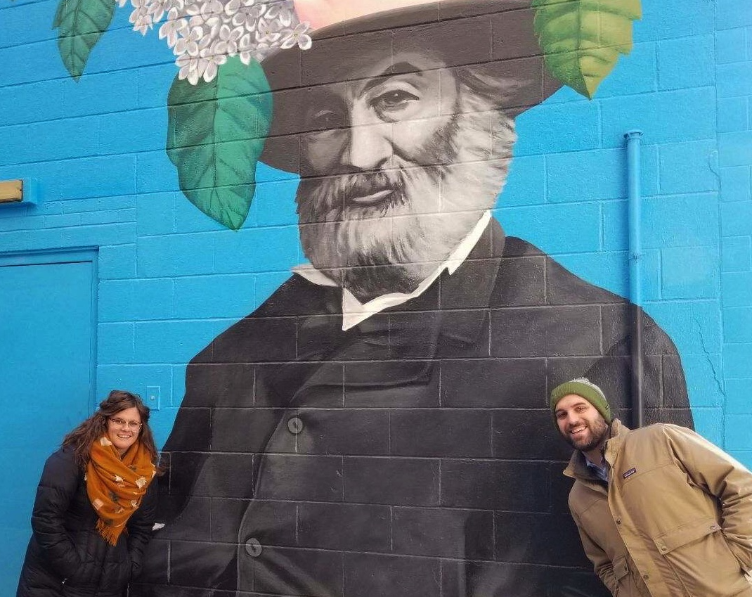 Amanda Golden and Josh Lapp of Designing Local pose in front of Tim Parsley's Walt Whitman mural in downtown Fort Wayne.