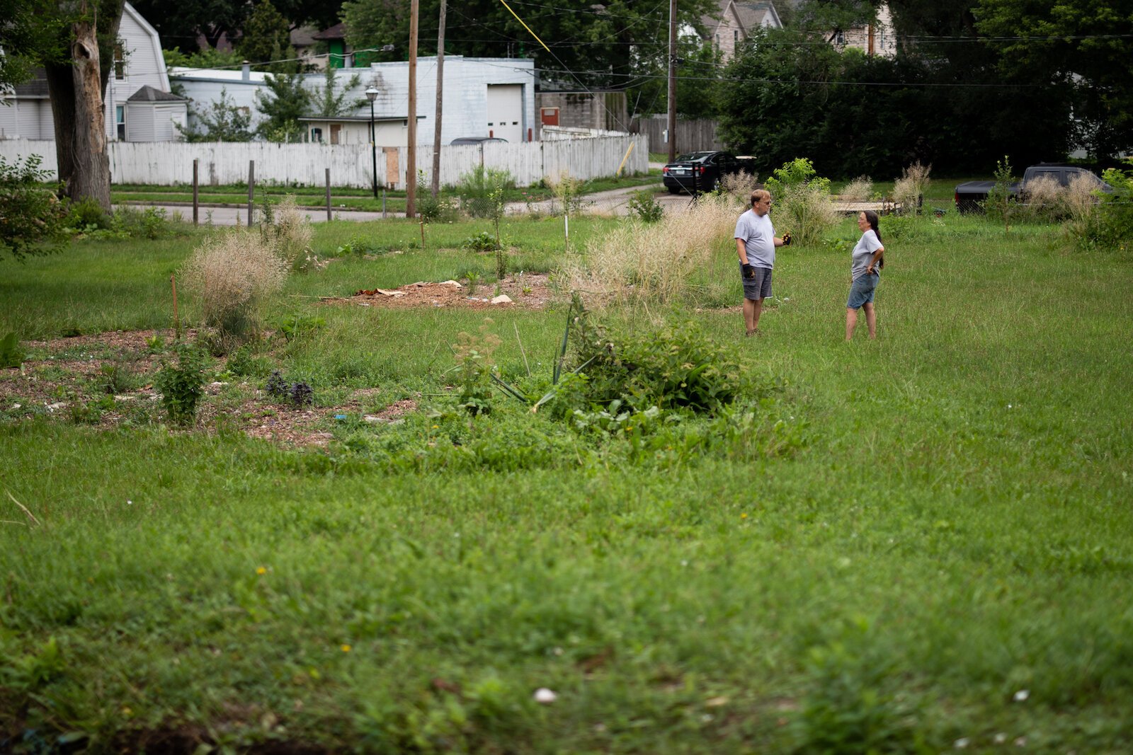 Diana Hart, right, talks with a contractor at Poplar Village Gardens.