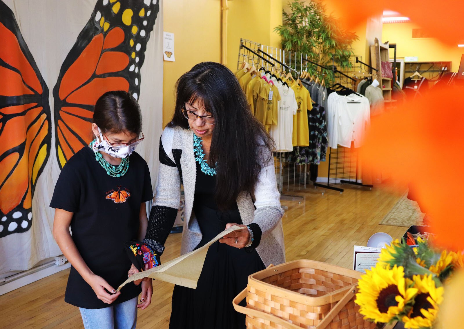 Artist Emily Guerrero, right, teaches granddaughter about ofrendas.
