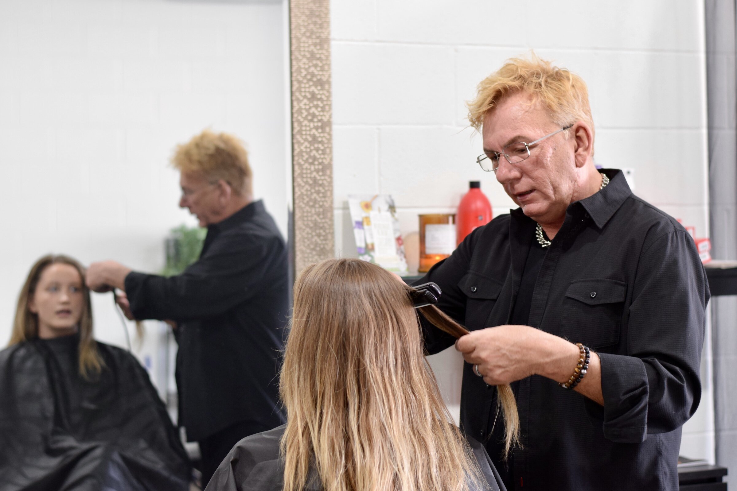 Michael Schram, owner of Michael Michael's Salon and Spa, styles a client's hair.