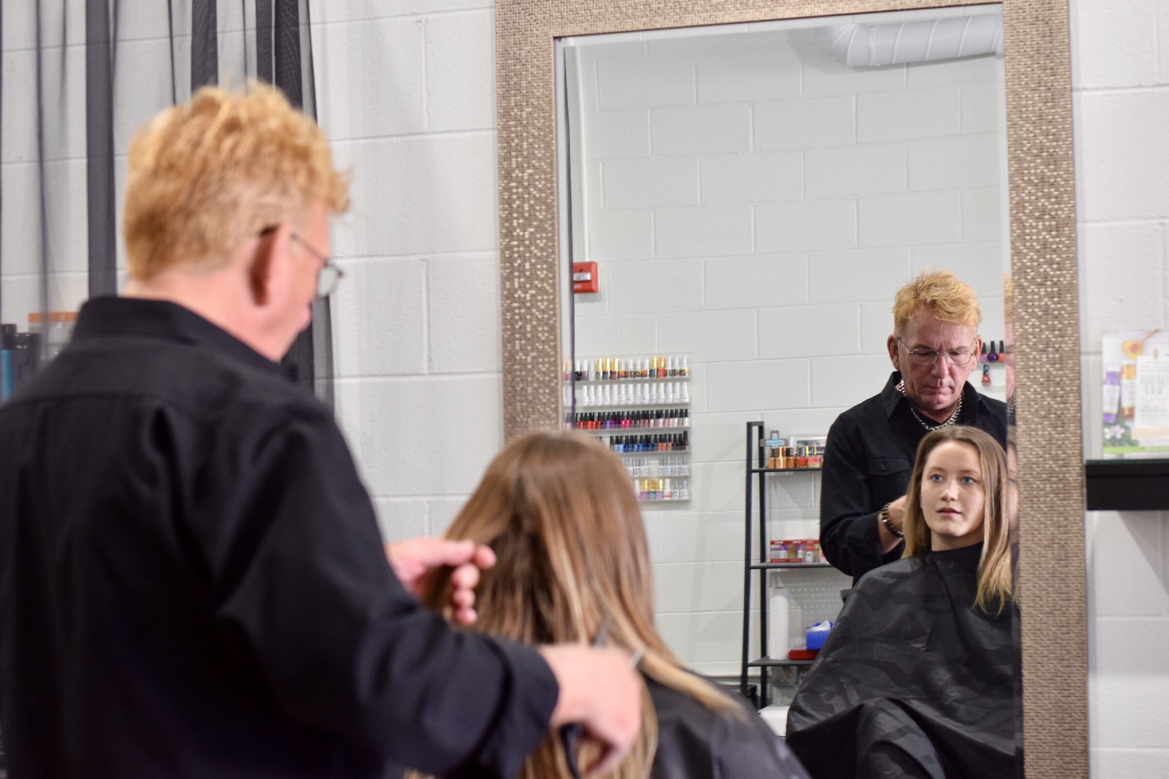 Michael Schram, owner of Michael Michael's Salon and Spa, styles a client's hair.