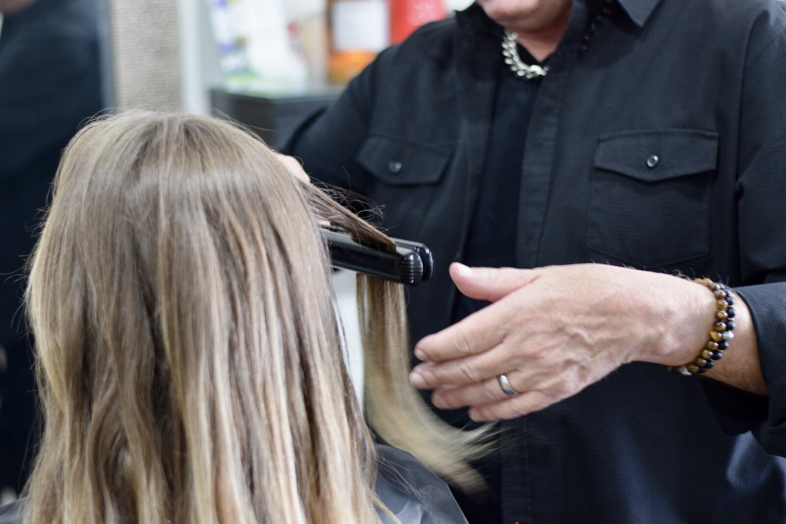 Michael Schram, owner of Michael Michael's Salon and Spa, styles a client's hair.