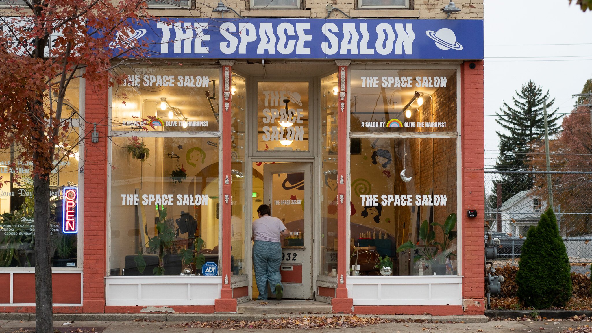 Olive enters the front door of The Space Salon on South Calhoun Street.