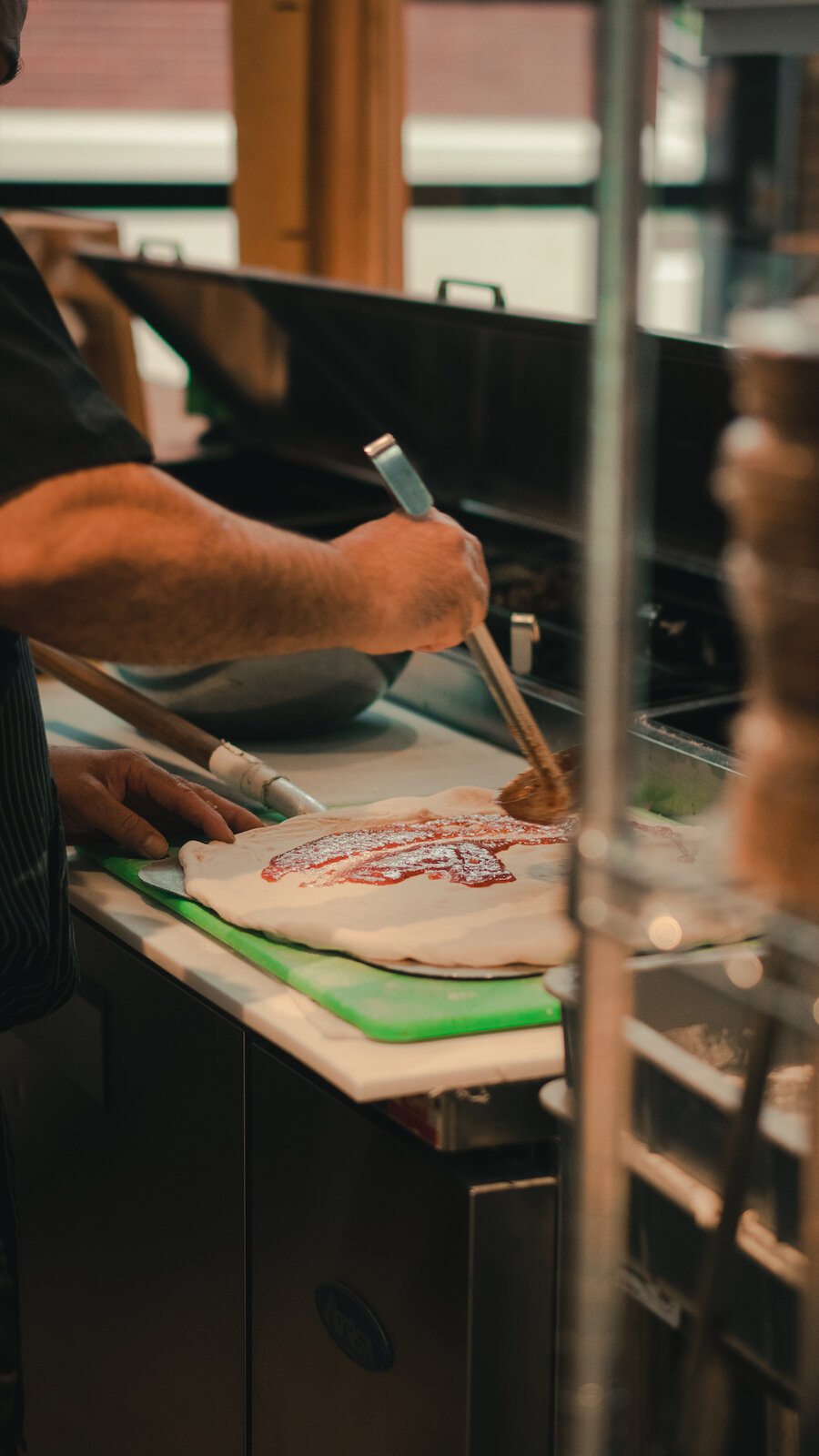 Johnny Bojinoff, owner of Johnny OX Pizzeria, makes a pizza.