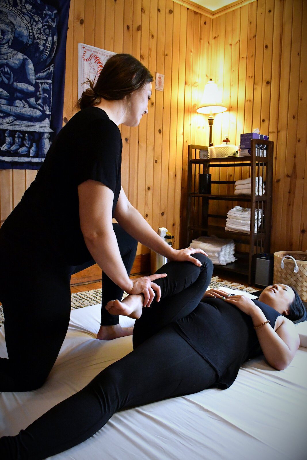 Julia Hyndman, Owner of Tulip Tree Healing, practices Thai massage with a client.