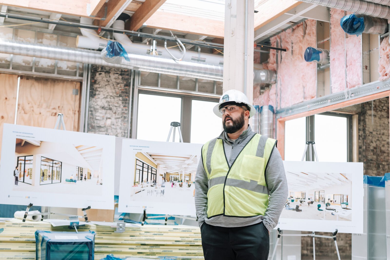 Riley Johnson, Director of the Amp Lab at Fort Wayne Community Schools, speaks with members of the media inside the Amp Lab's future space in Building 31 of Electric Works. (December 2021) 