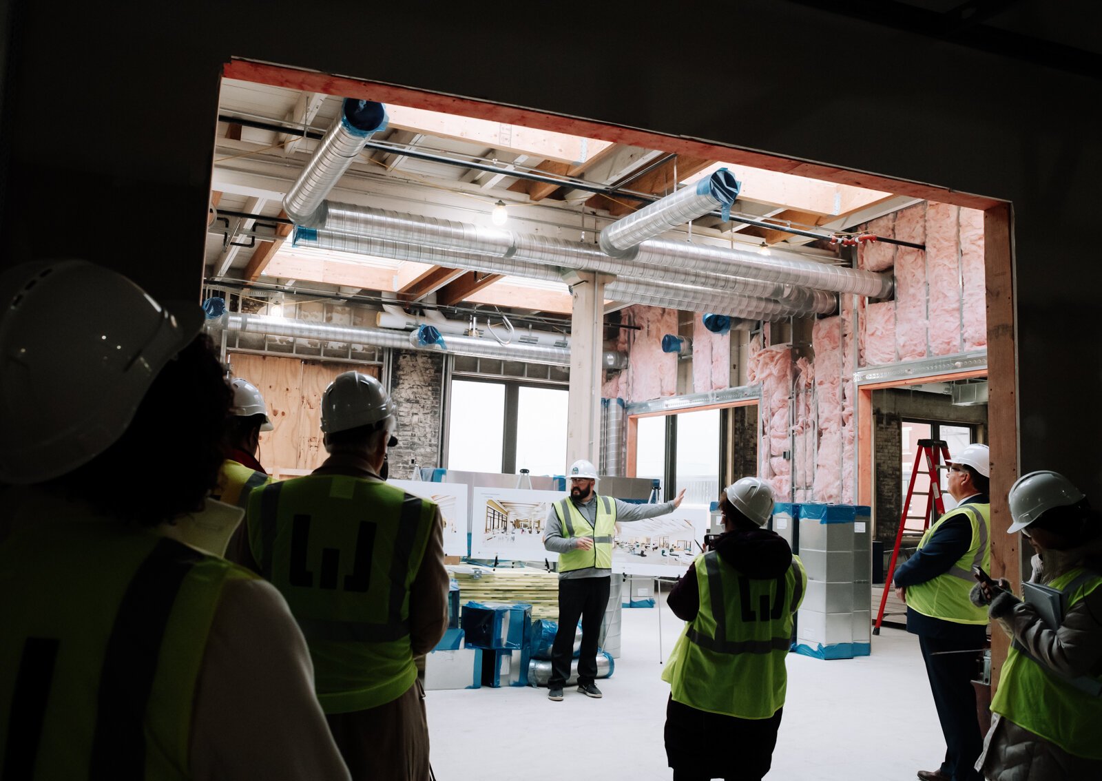 Riley Johnson, Director of the Amp Lab at Fort Wayne Community Schools, speaks with members of the media inside the Amp Lab's future space in Building 31 of Electric Works. (December 2021) 