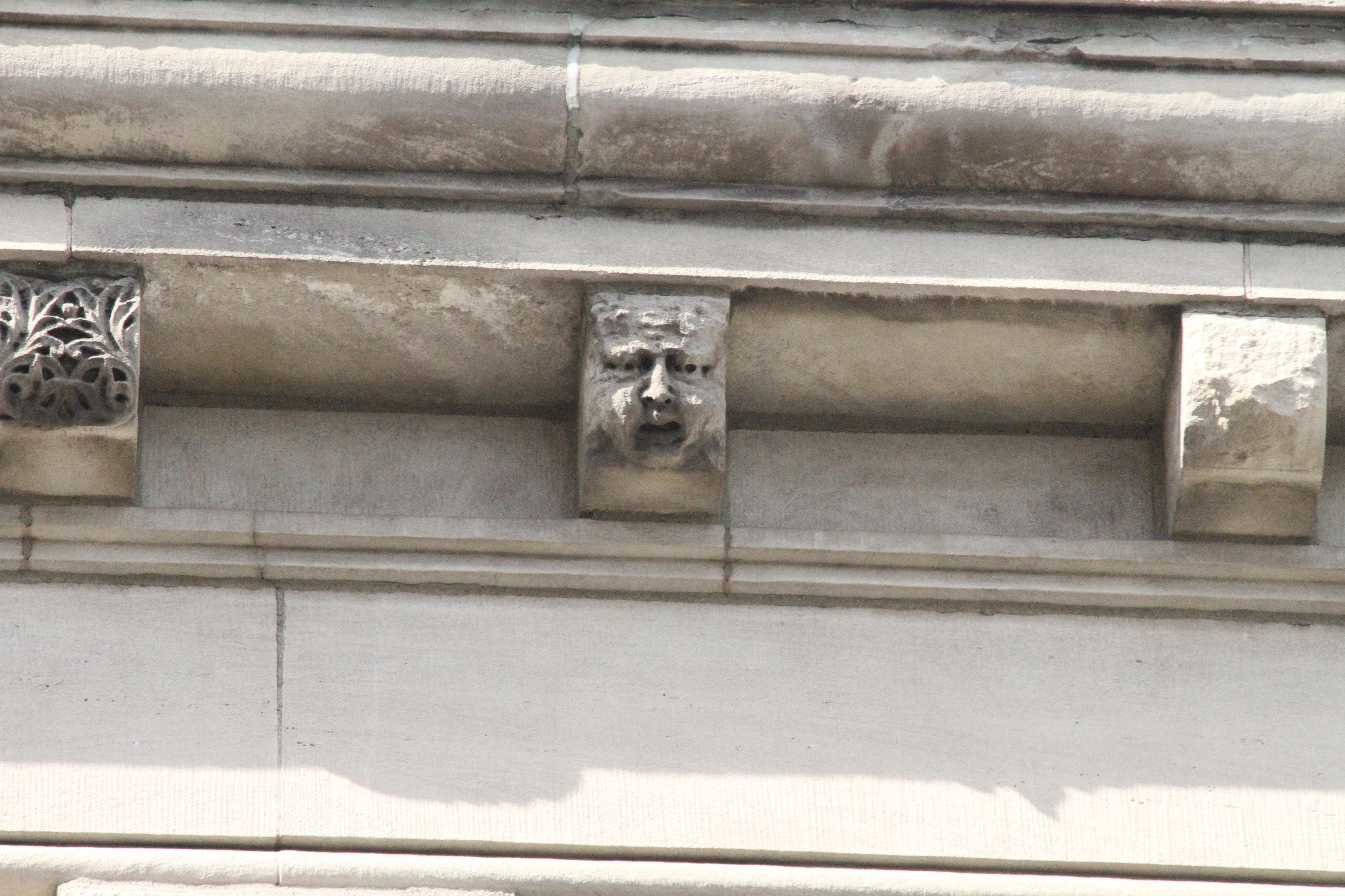 “Modillions” atop the Schmitz Block building have carved faces. 