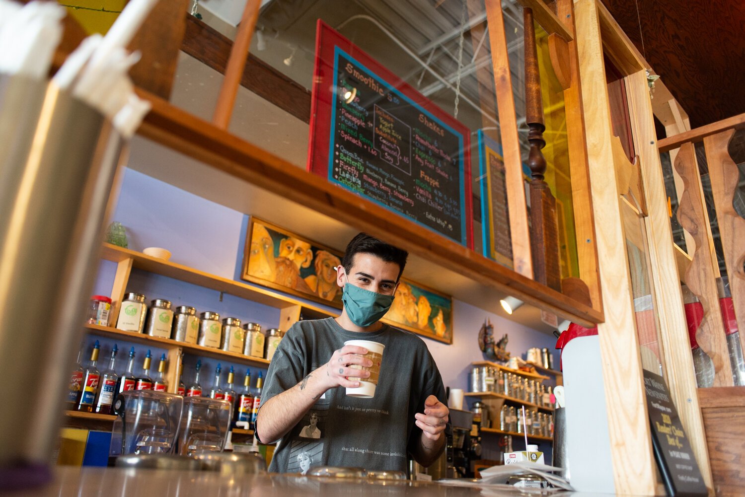 Barista Caleb North serves a hot pumpkin spice chai with almond milk at Firefly Coffee House.
