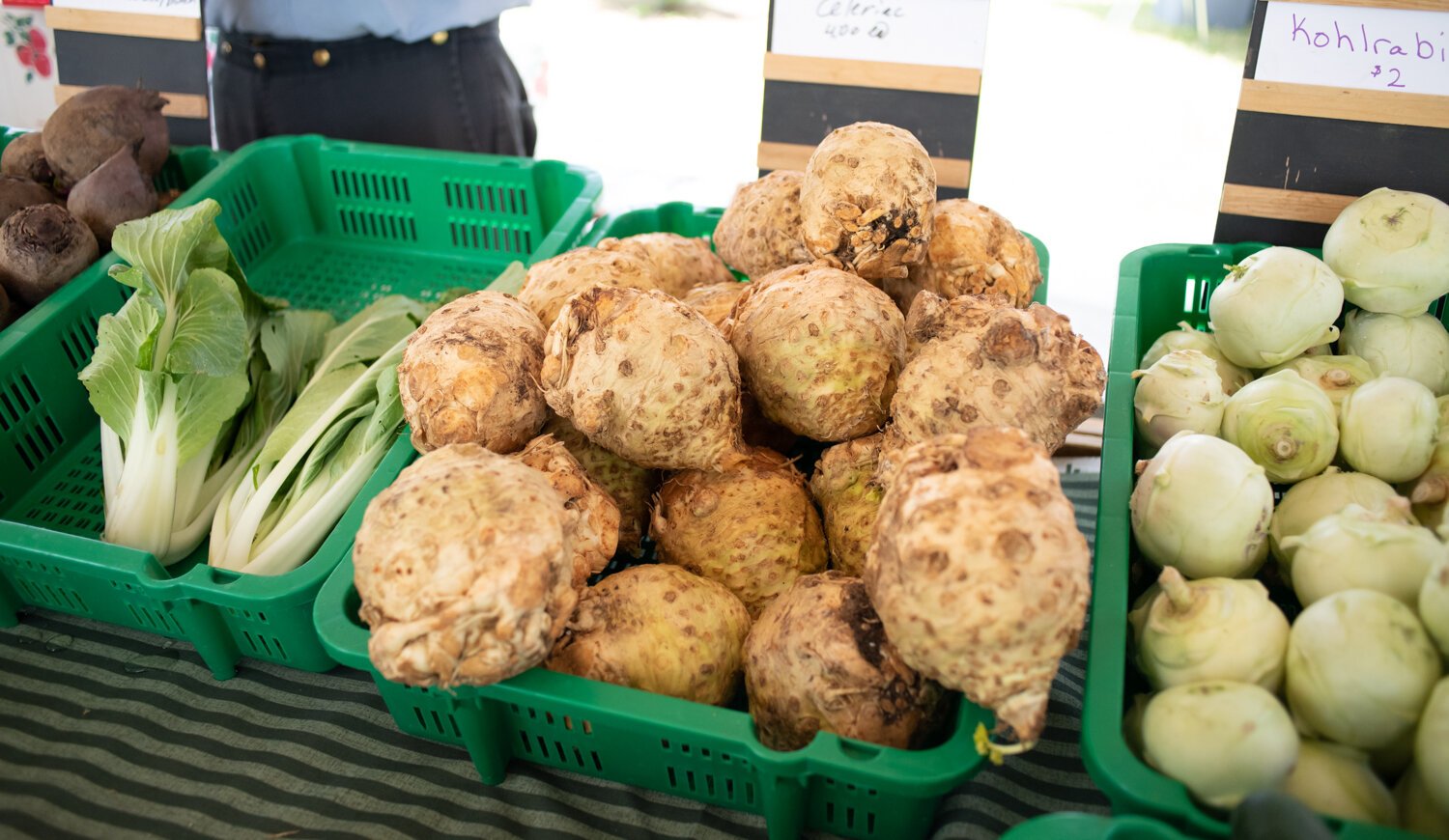 Fresh produce is displayed at the Berry Hill Farm table during the Fort Wayne's Farmers Market at McCulloch Park on Saturday June 19, 2021.