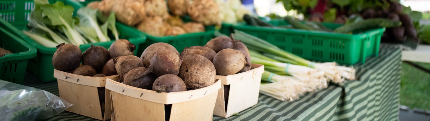 Fresh produce is displayed at the Berry Hill Farm table during the Fort Wayne's Farmers Market at McCulloch Park on Saturday June 19, 2021.