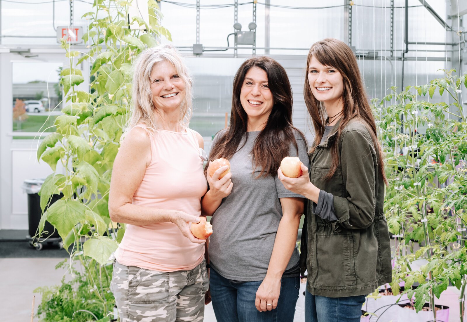 From left Charlotte Wehr, Camille Schuelke, and Kristen Canan of the Parkview Well-Being Team participate in the national Great Apple Crunch at the Parkview Community Greenhouse at 1716 Beacon St. 