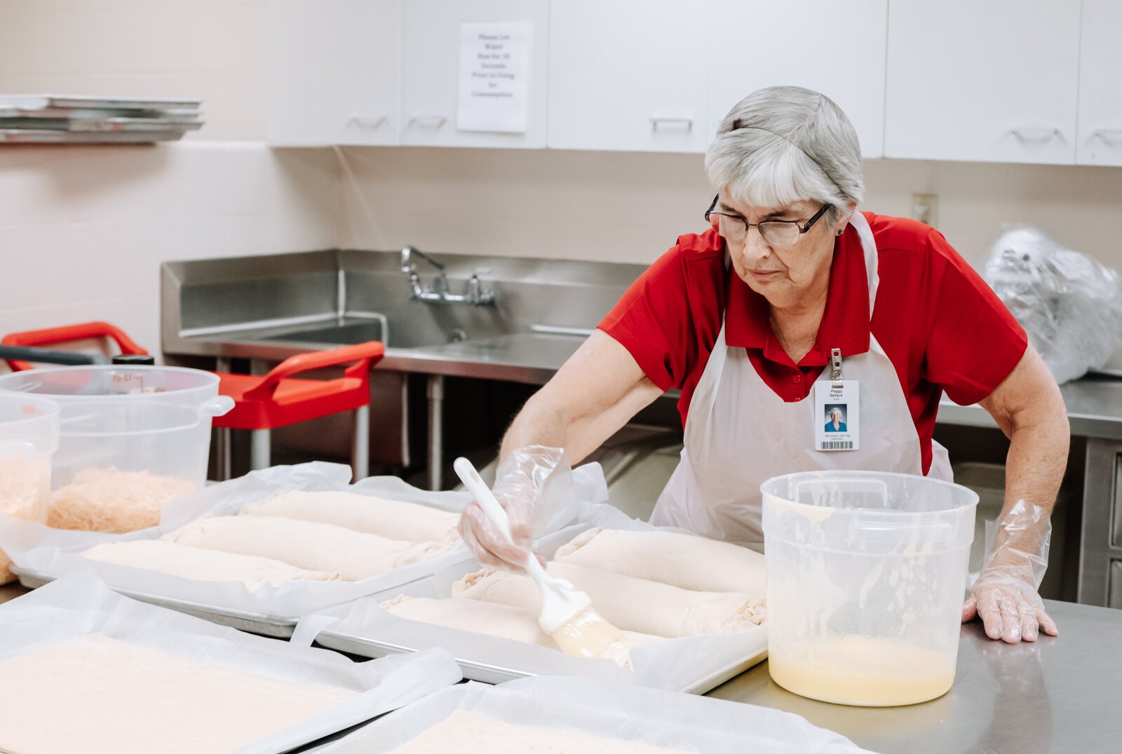 Landes's staff member Peggy Selleck prepares Sausage Bread for lunch at Manchester Junior-Senior High School, which features local pork.