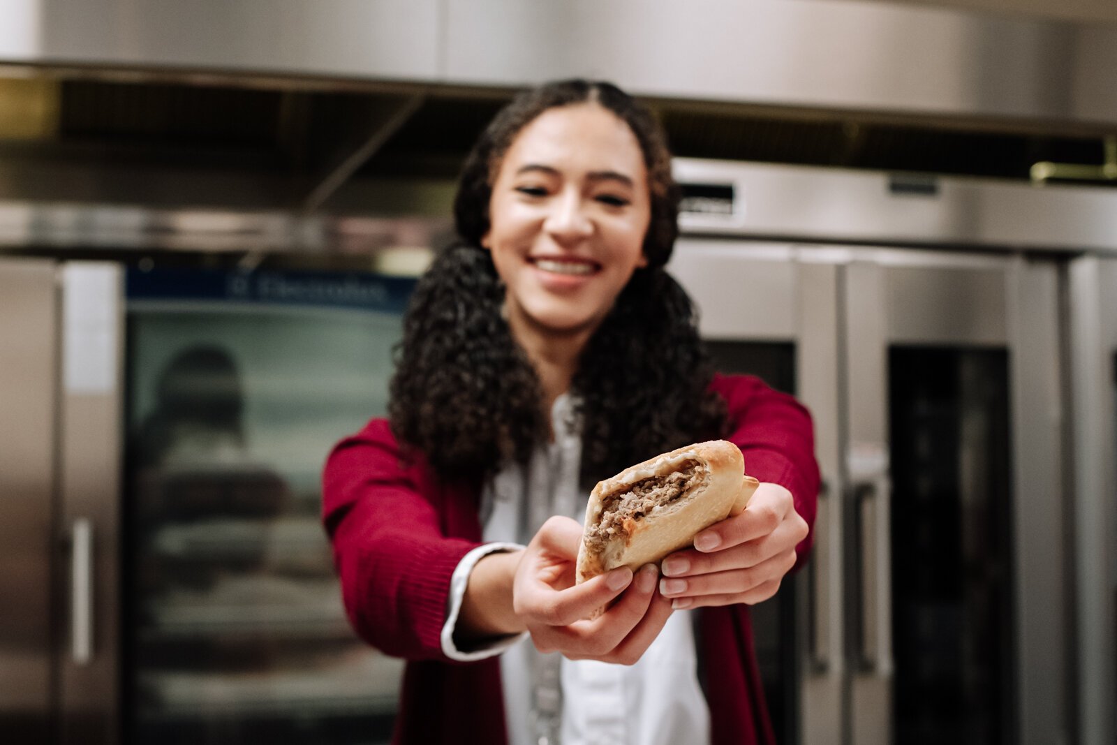 Senior Morgan Metzger at Manchester Junior-Senior High School taste tests sausage bread made with local pork from 4-H as part of the school's Farm to School efforts.