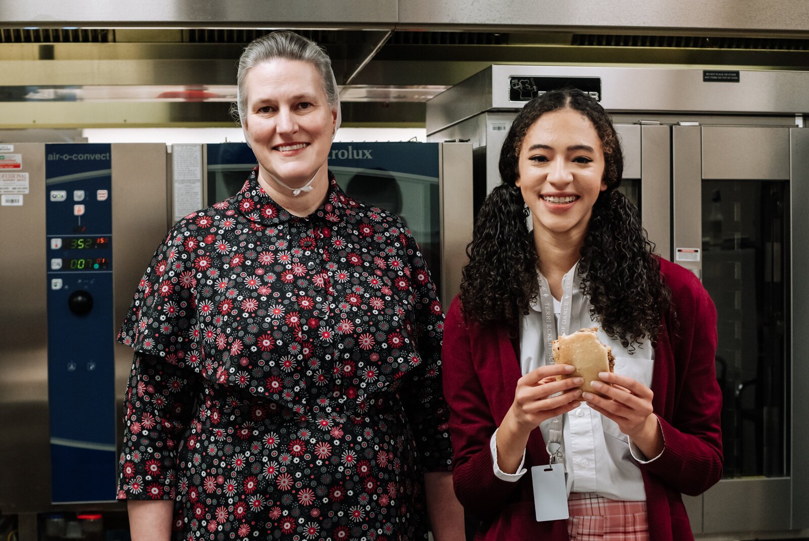 Becky Landes, Food Service Operation Manager, left, enjoys preparing locally sourced meals for students at Manchester Junior-Senior High School, like Senior Morgan Metzger, right.