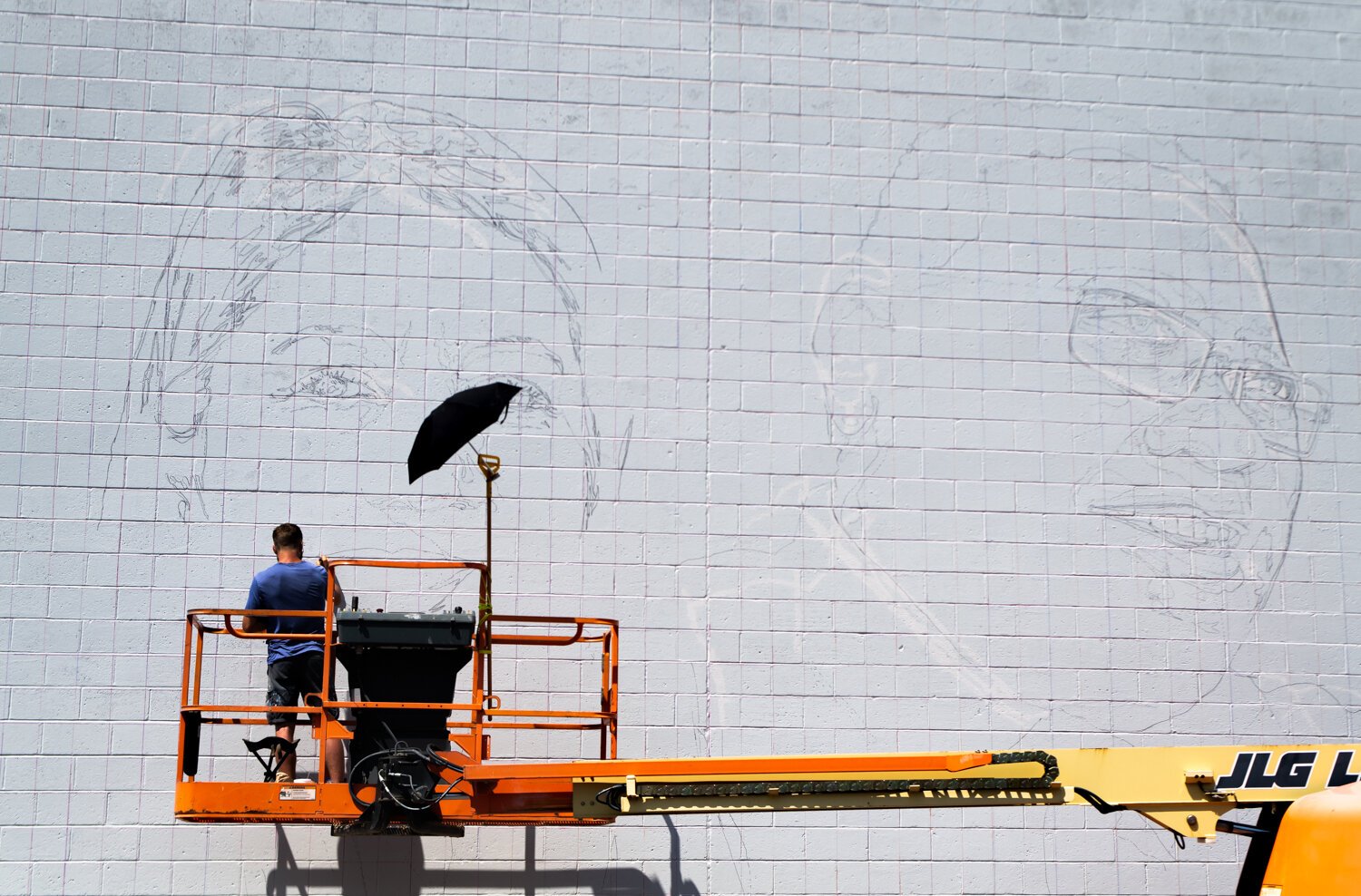 Muralist Mitchell Egly works on the Southwest Faces of the Fort mural at 1818 Bluffton Rd.
