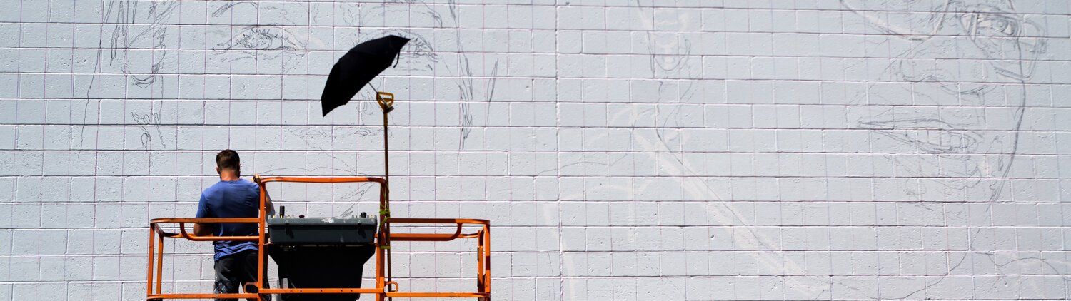 Muralist Mitchell Egly works on the Southwest Faces of the Fort mural at 1818 Bluffton Rd.