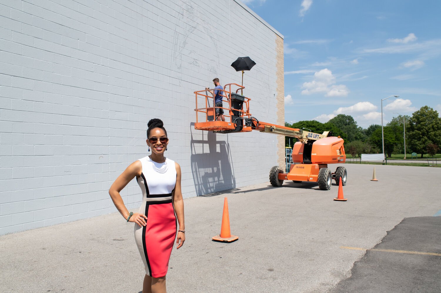 Réna Bradley, Chair on the Faces of the Fort Committee, stands in front of the Southwest Faces of the Fort mural at 1818 Bluffton Rd.