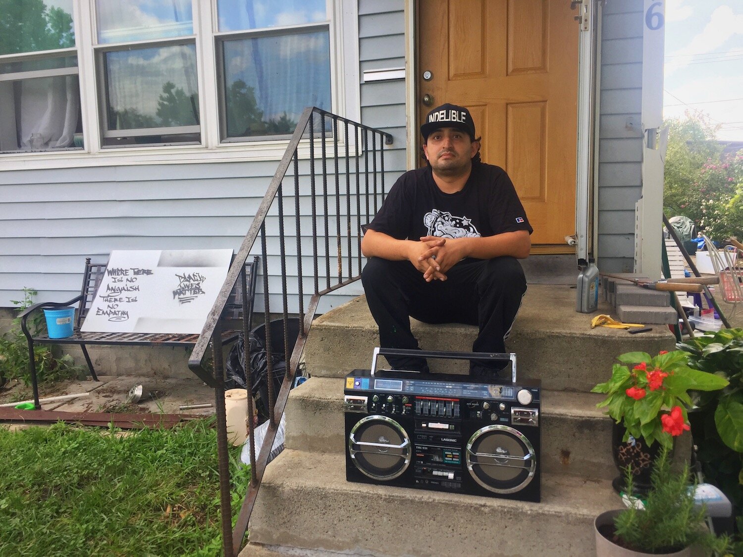 Francisco Reyes sits outside his house in Southeast Fort Wayne where he's building a culture around Hip-Hop.
