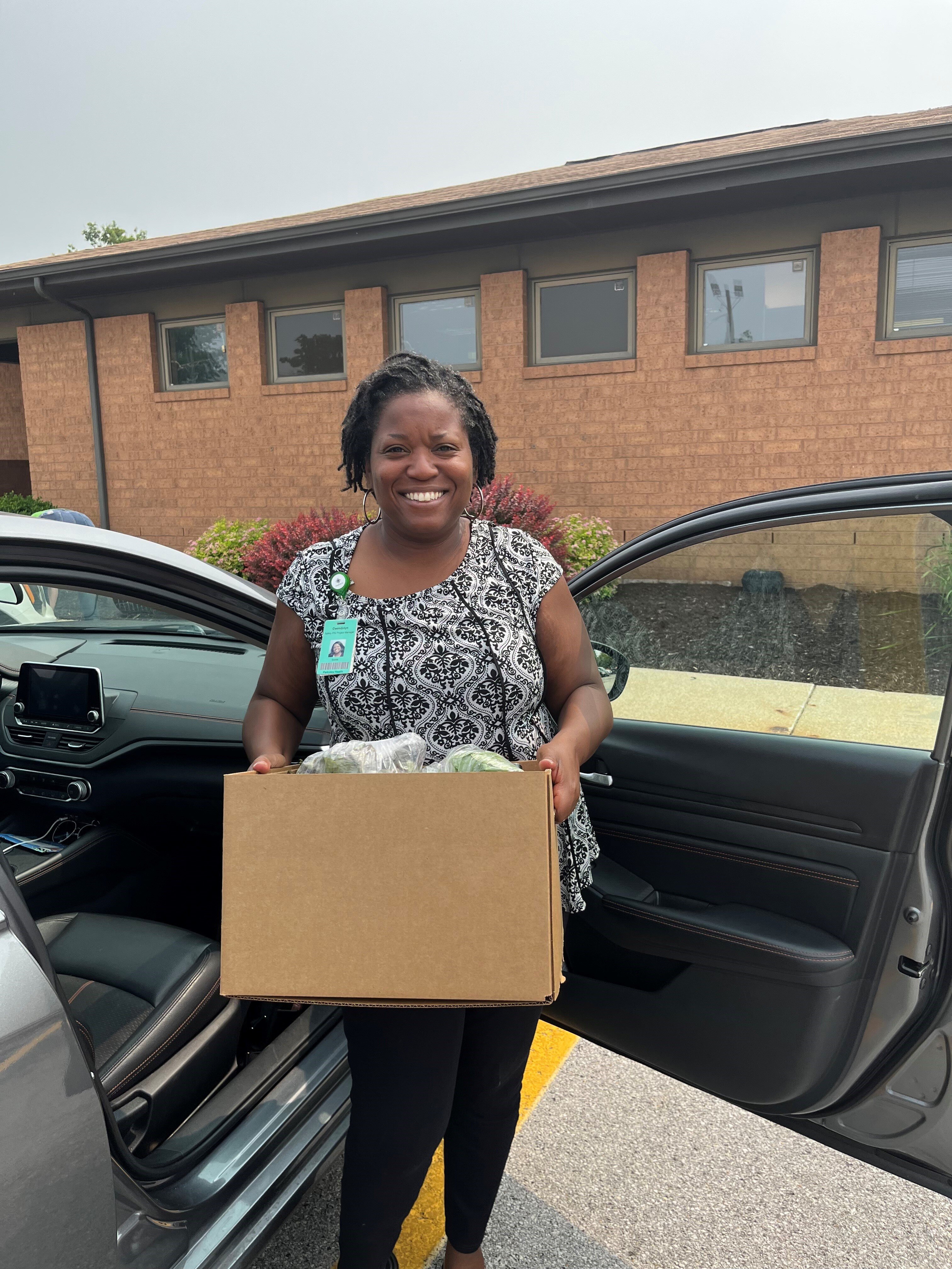 Gwendolyn Masterson gets ready to deliver a box of produce as part of the FreshFoods4Youth program offered through Parkview.