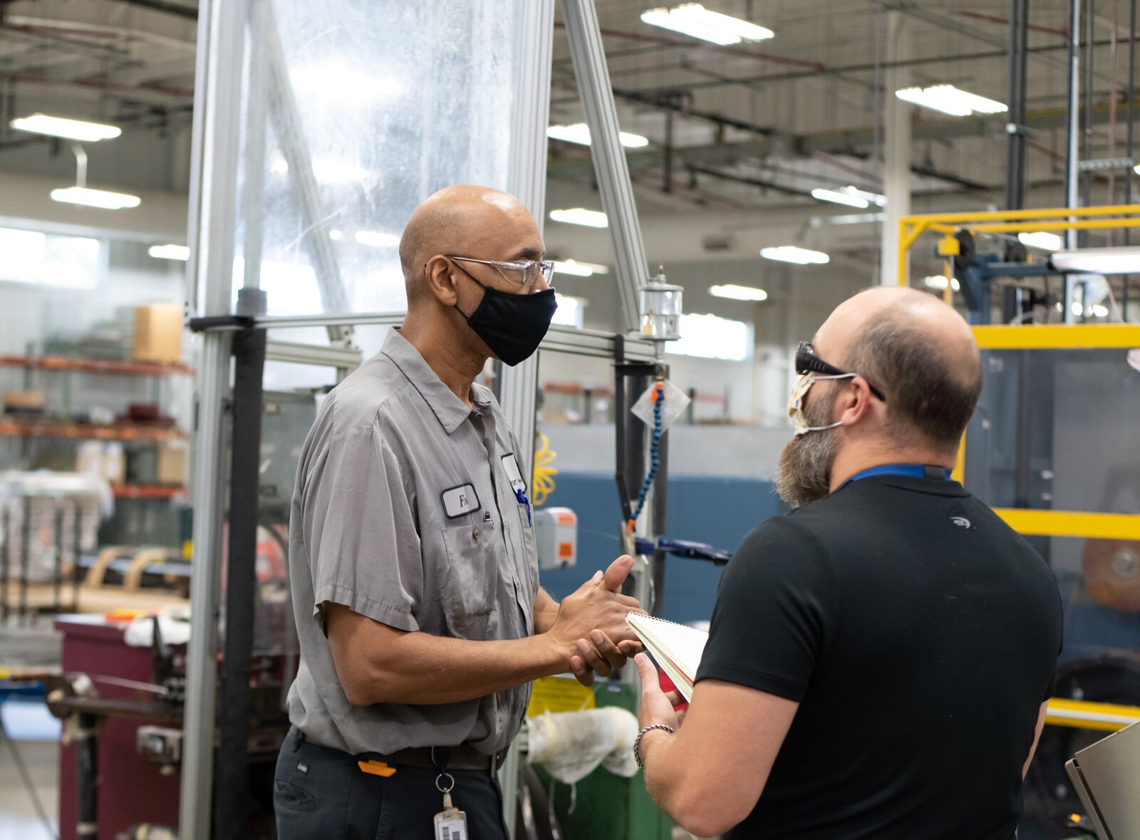 Employees Fred Billingsley, Wiredrawer, left, gives feedback to Clifford Griffith, Engineer Tech in order to improve work at Fort Wayne Metals on Ardmore Ave. on September 27, 2021. 