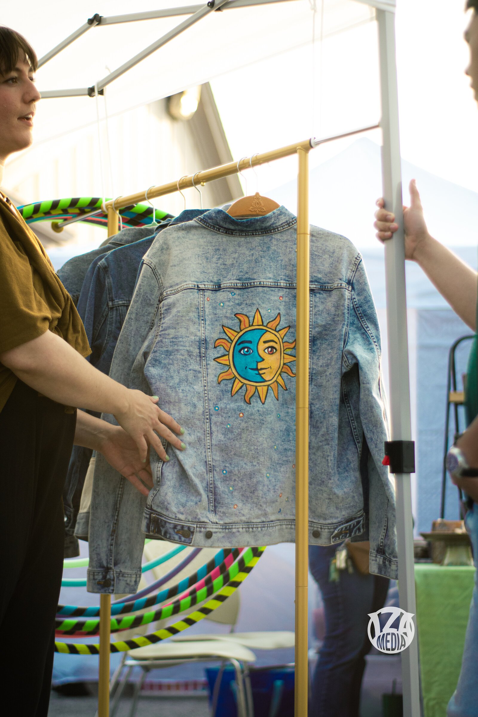 Julia Hyndman talks with vistors at her booth at Garden Night Market.