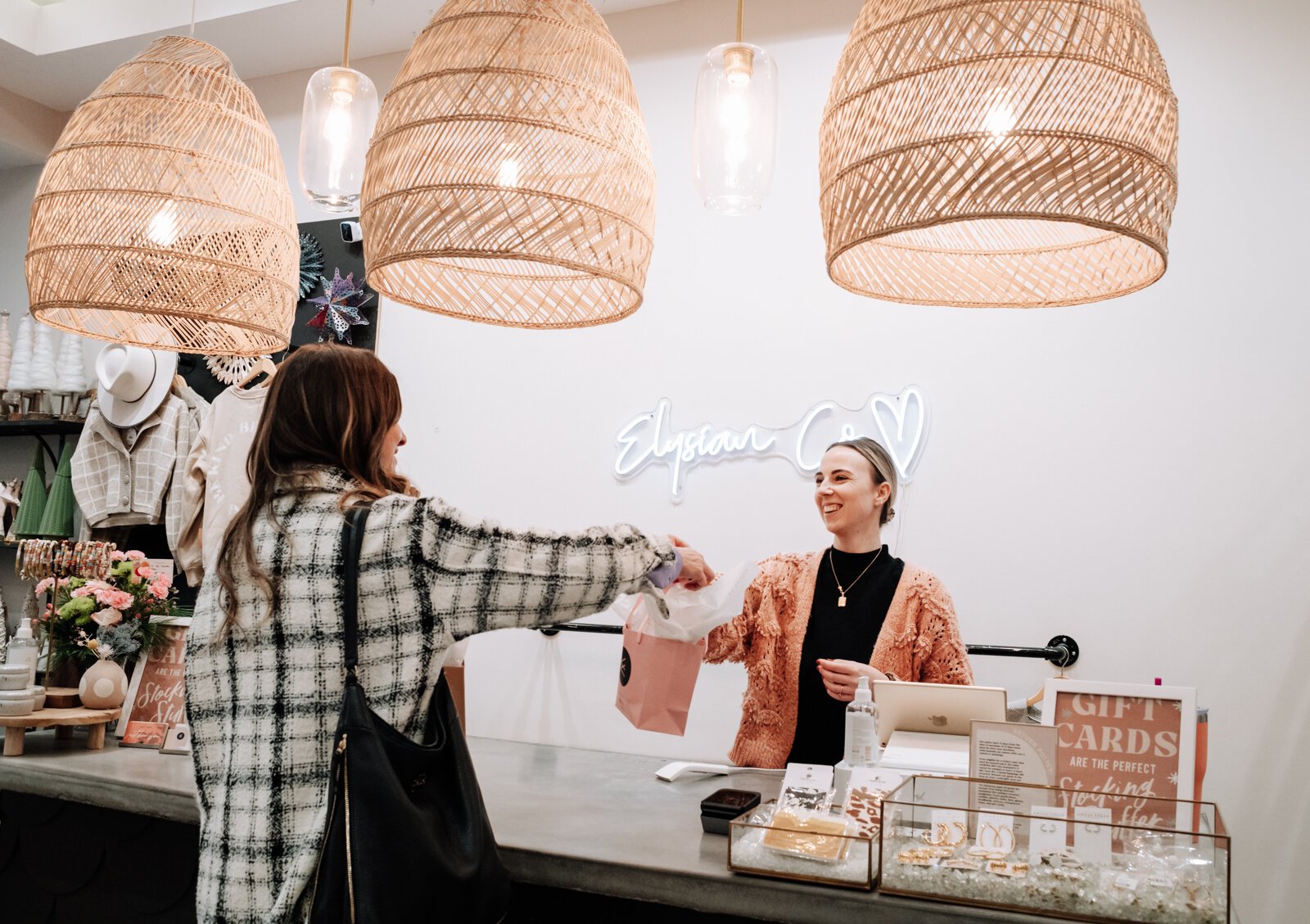 Sales Manager Rileigh Zickafoose helps a customer check out at Elysian Co. at 110 E. Center St. in Warsaw.