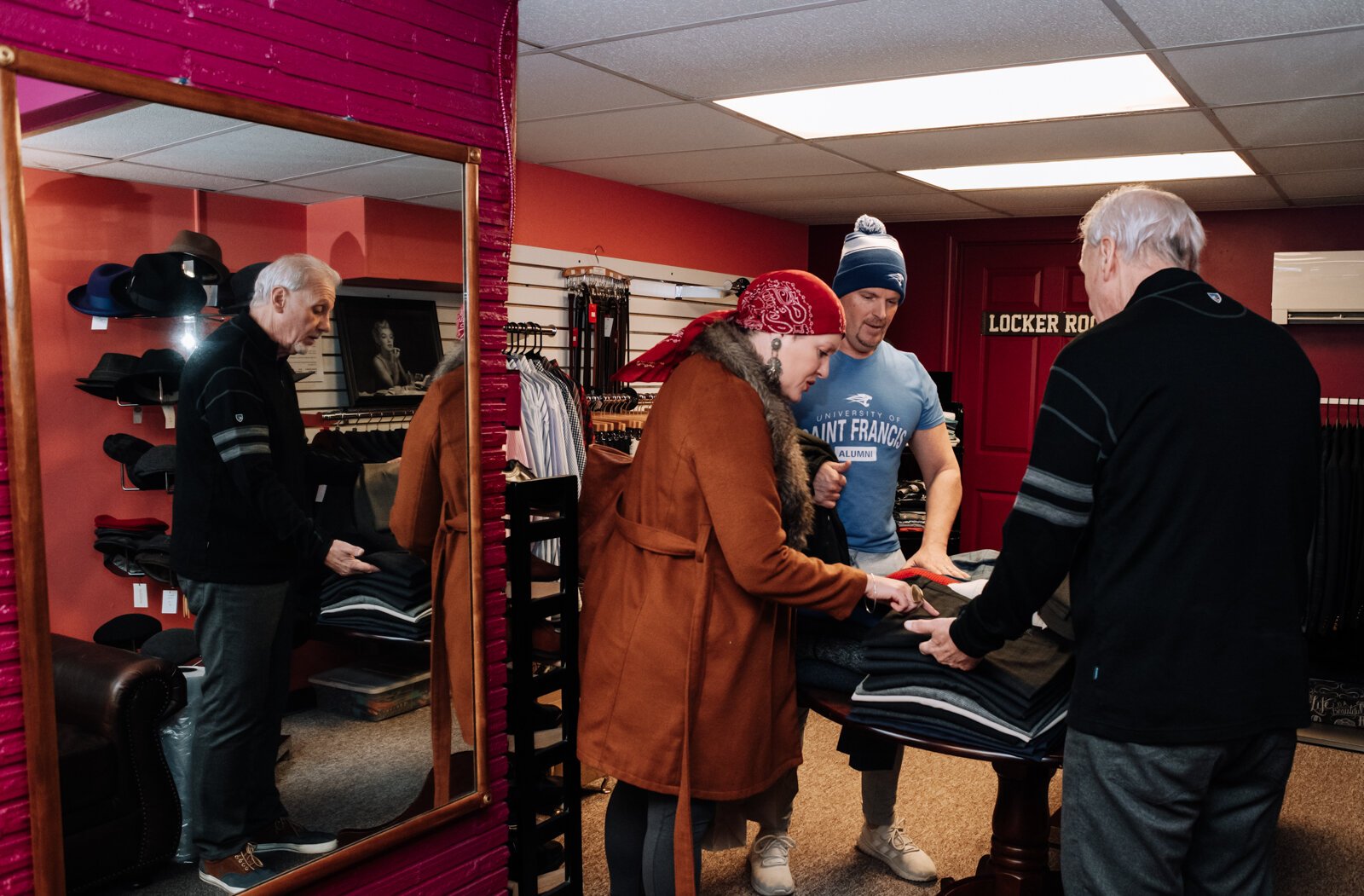 Owner David Rabideau helps guests Vienne and Tony Didier while shopping at David Talbott Collection at 532 West Berry St.