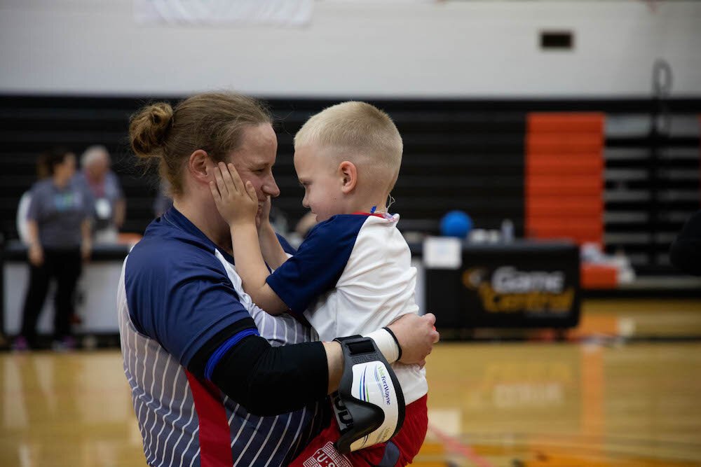 Lisa Czechowski, a member of the qualifying USA women’s goalball team, celebrates with her son.