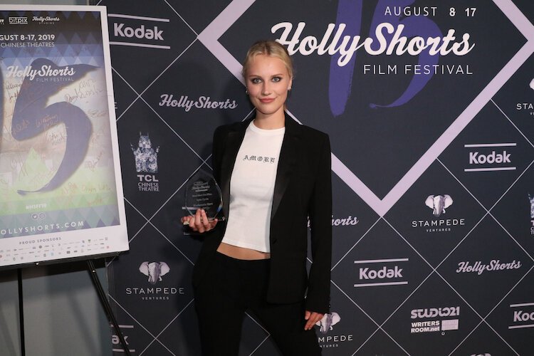 Hart poses with her award at the HollyShorts Film Festival 2019.
