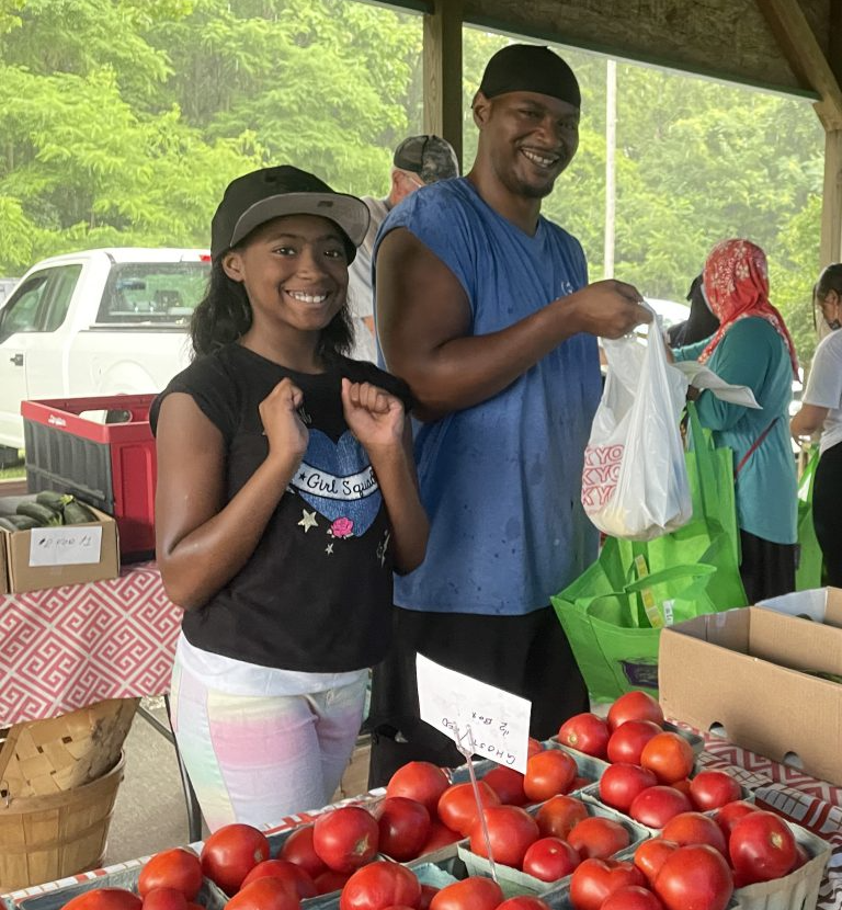 Attendees shop for fresh fruits and veggies at the HEAL Market.