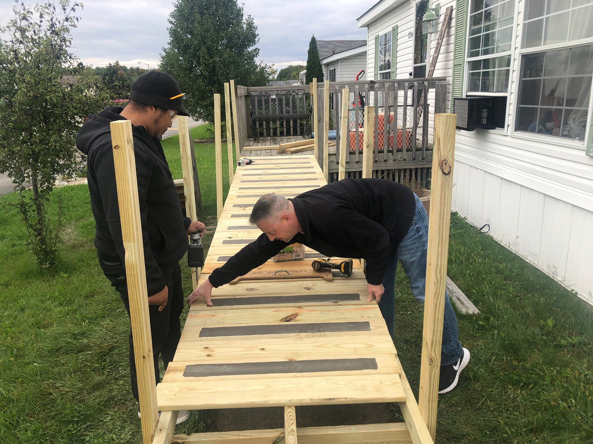 NeighborLink volunteers collaborate on service projects in Fort Wayne neighborhoods, like building ramps.