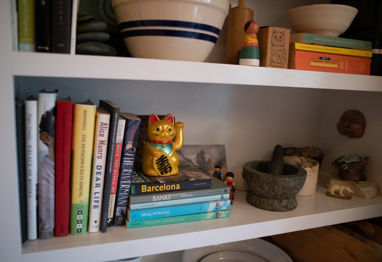 Books add pops of color to shelving in the kitchen of Scott and Catherine Hill's home.