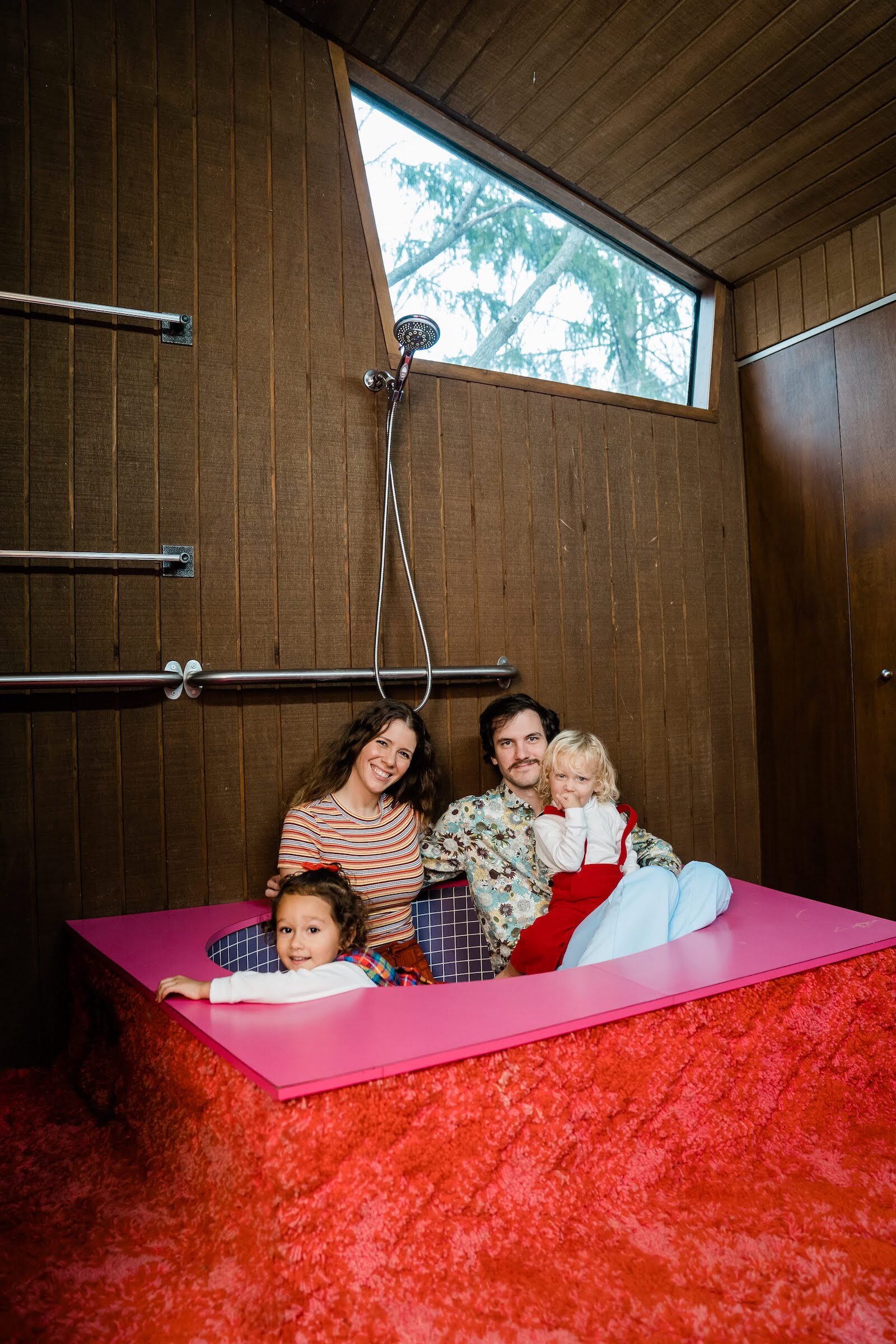 Alysha and Nate Jackson with their children in the shag-covered tub.