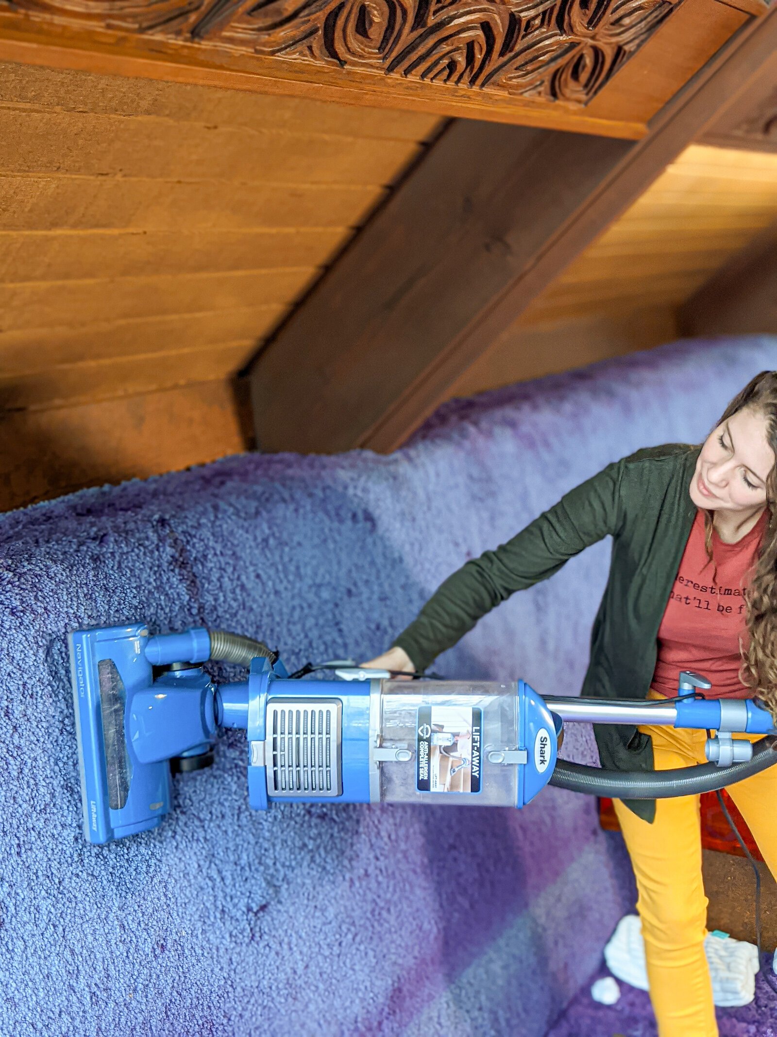 Alysha Jackson vacuums the walls of her new house.