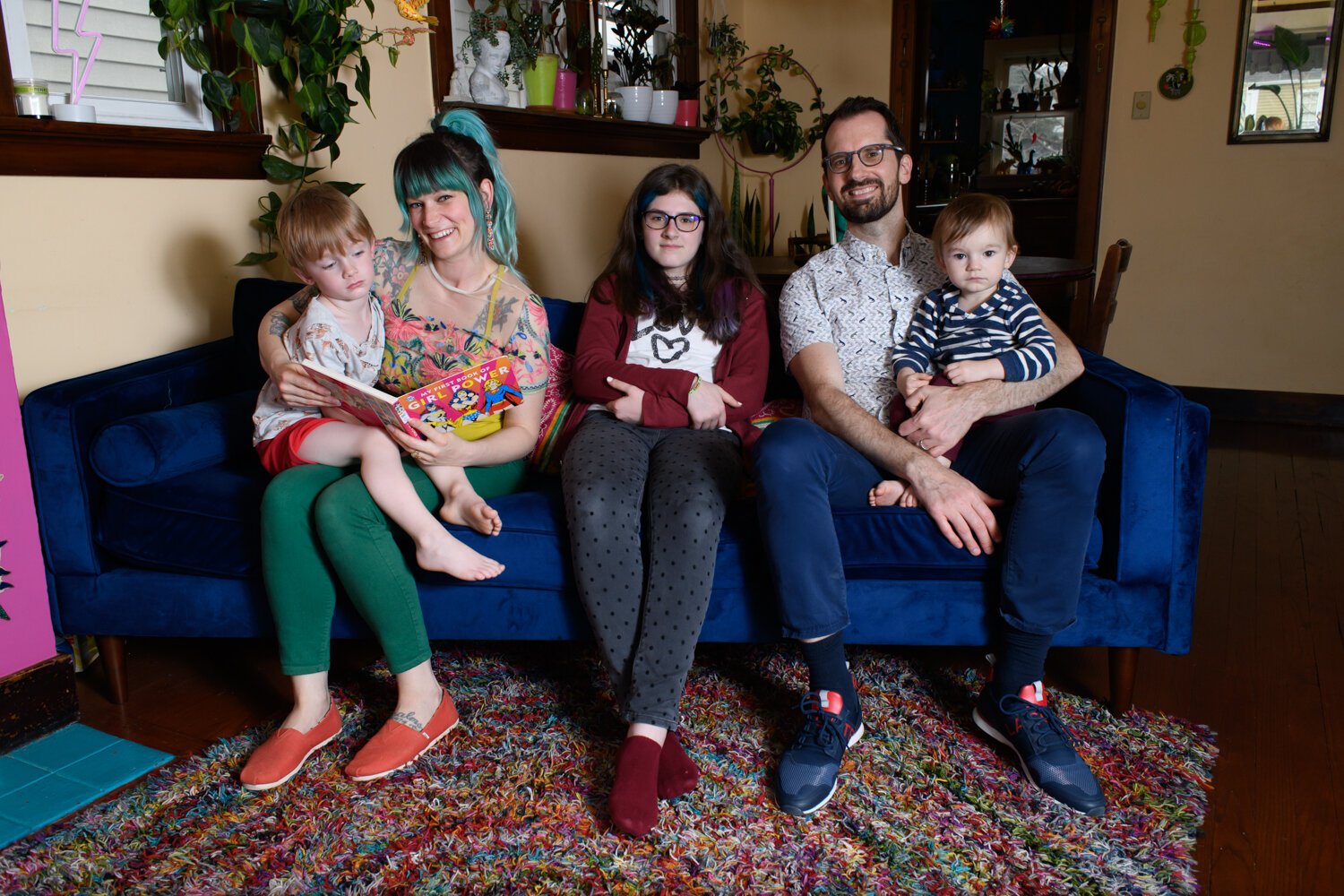 The Porter Family, from left, includes Oliver, 4, Lyndsy Rae, Giana, 12, Ben, and Rew Jupiter, 1, in their living room of their home.