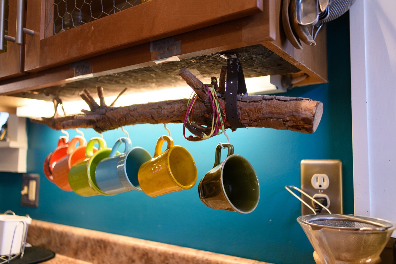 Mugs are hung from a piece of the Porter’s very first Christmas tree in the kitchen at the Porter family home.