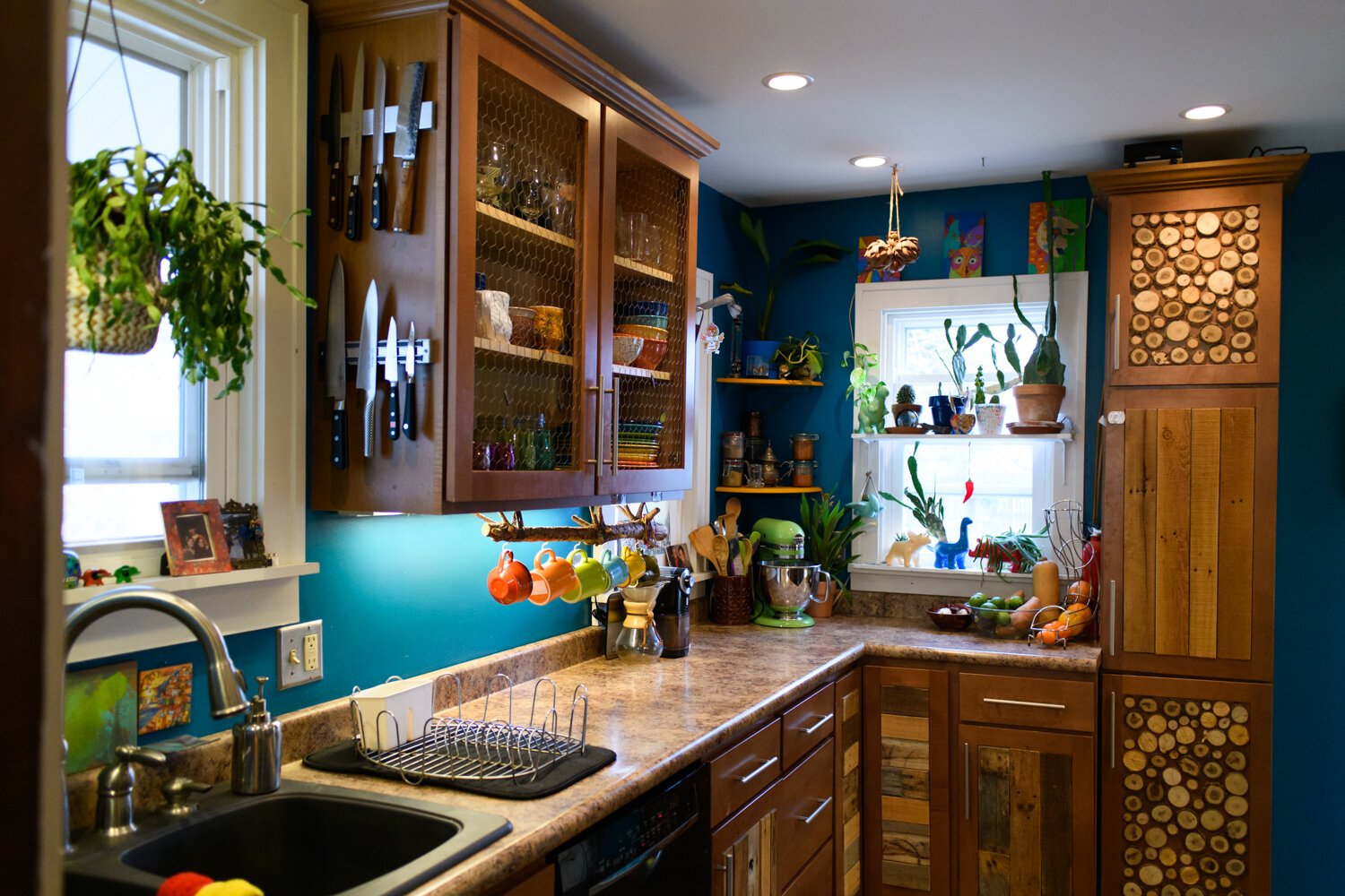 The kitchen features a lot of plants and woodwork at the Porter family home.