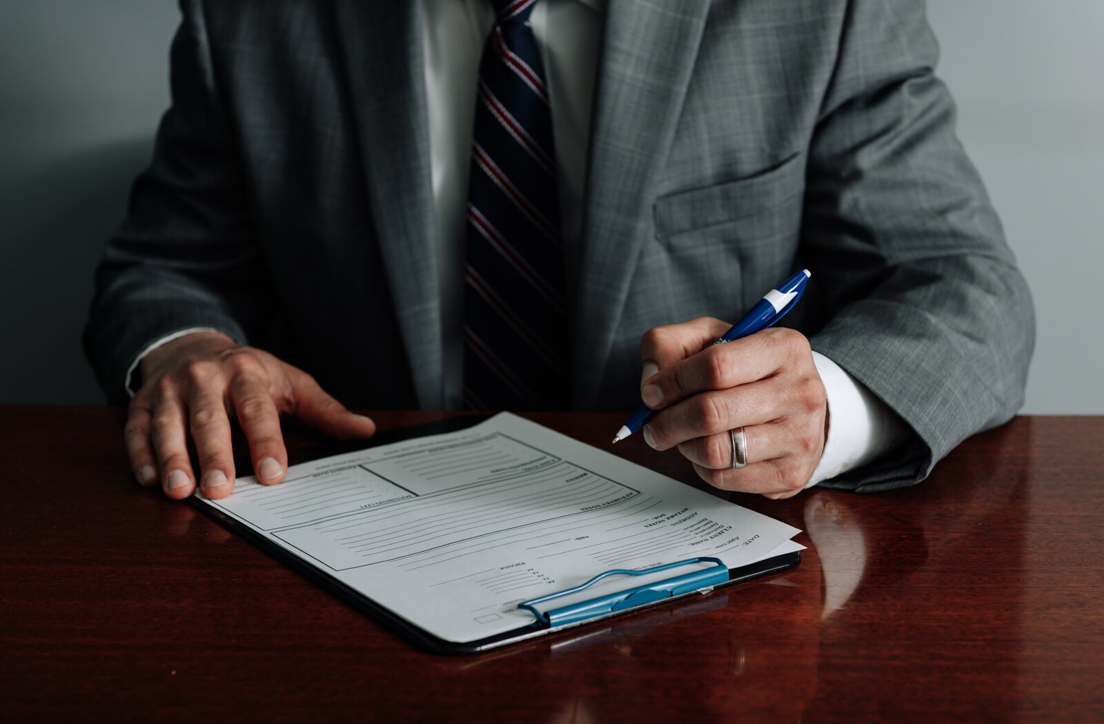 Immigration lawyer Brian A. Seyfried fills out a new client form at his office the Law Office of Brian A. Seyfried.