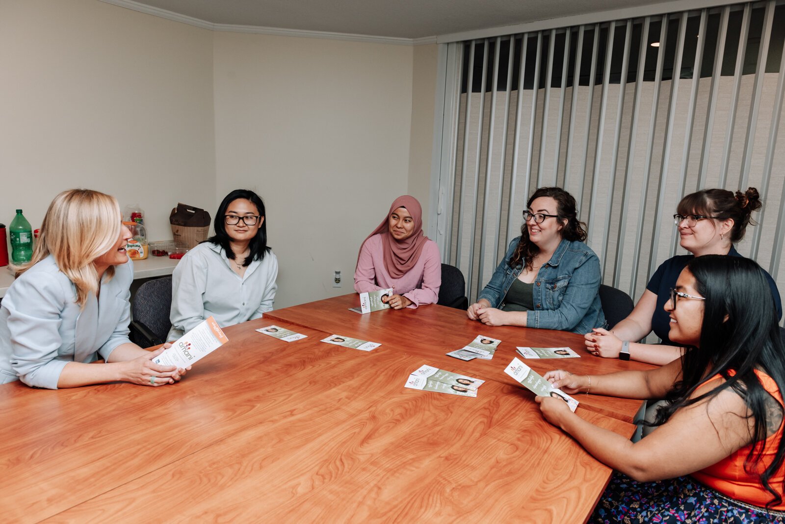 Employees speak during a meeting with Ewelina Connolly, CEO, at Amani Family Services in Fort Wayne.