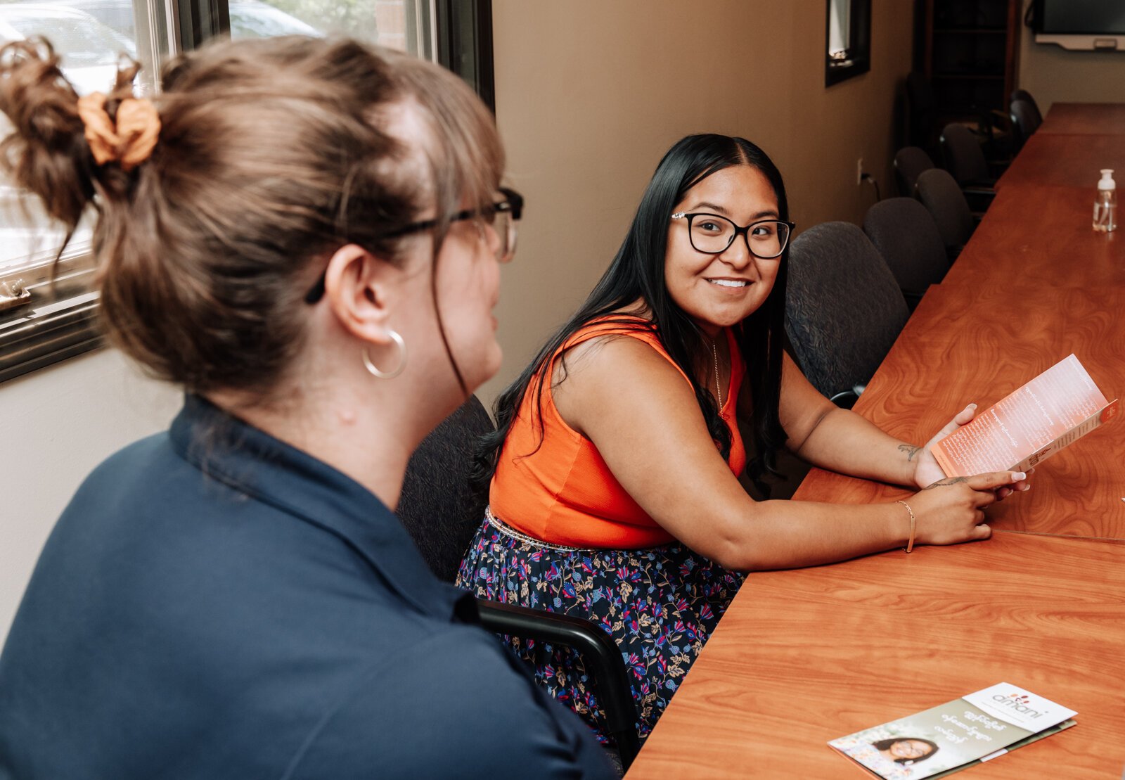 Adriana Buendia speaks during a meeting with Ewelina Connolly, CEO, and members of her diverse workforce at Amani Family Services in Fort Wayne.