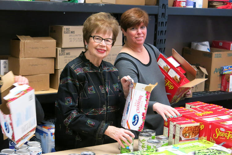 Volunteers Janet Finkel and Bonnie Pomerantz sort donations.
