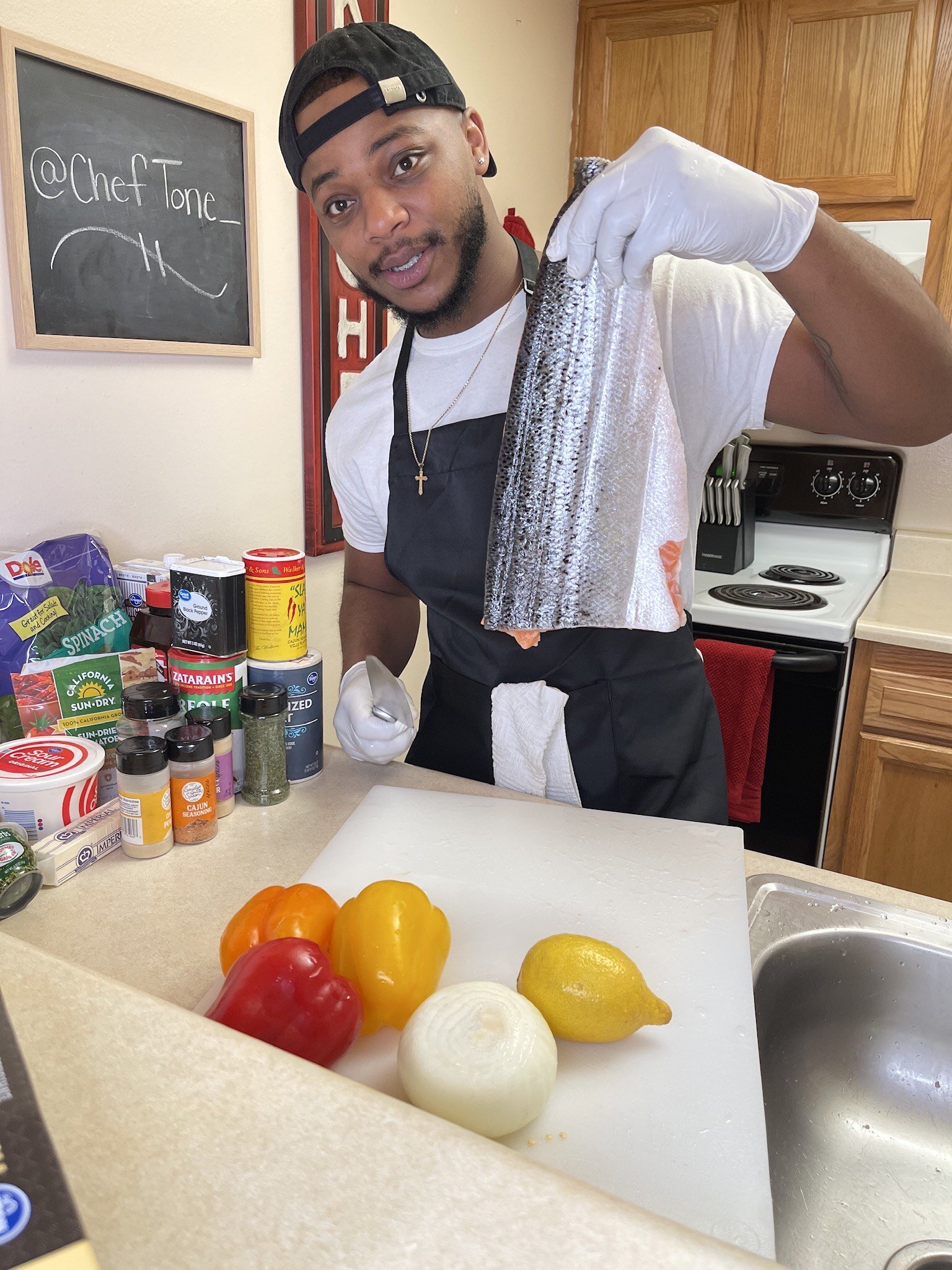 Chef Tone Wilson films a video for TikTok in his home kitchen.
