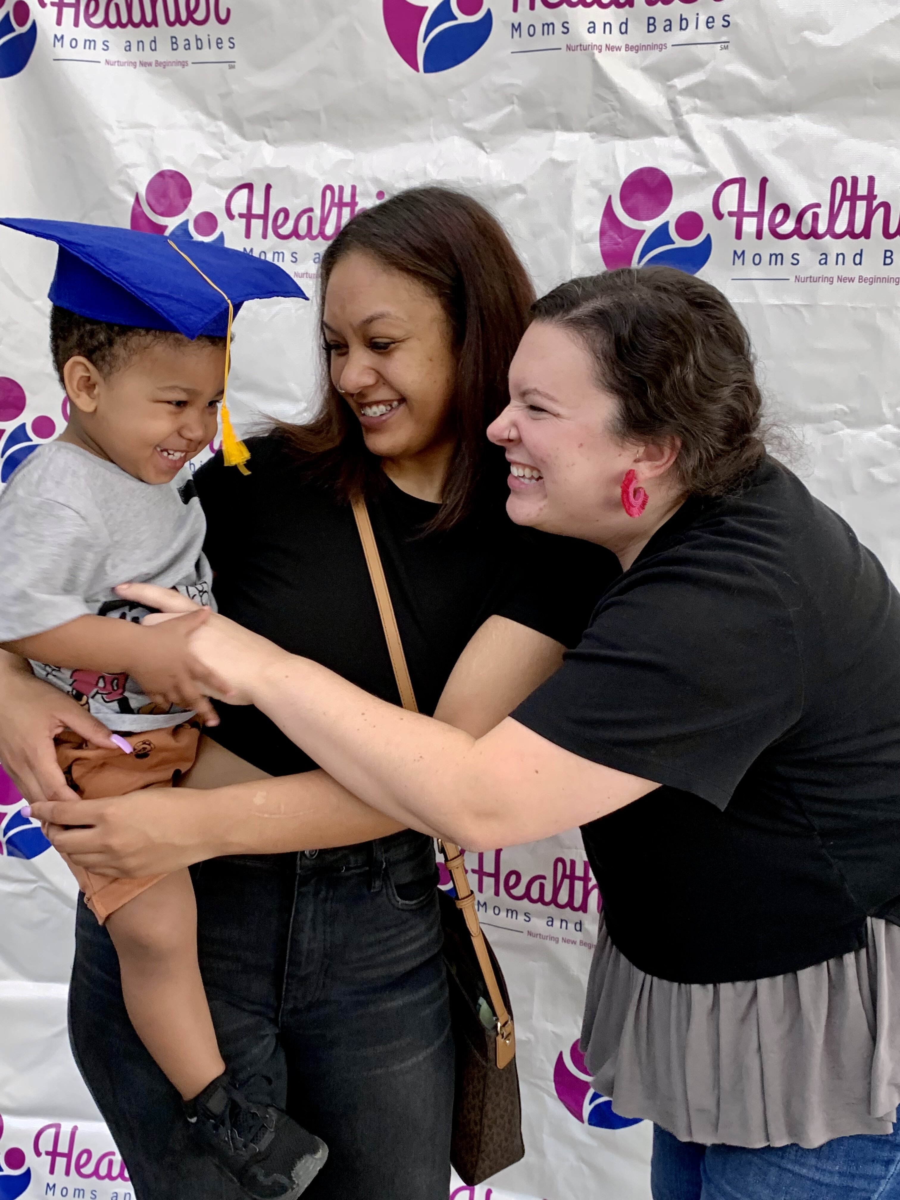 Pictures with their home visit nurse, this mom and baby graduate from the Nurse Family Partnership Program at Healthier Moms and Babies.